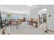 Spacious living room featuring natural light, terrazzo floors, and an open layout leading into the kitchen at 4720 Coronado S Way, Gulfport, FL 33711