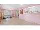 Spacious sun room needing renovation, featuring a pink wall and good natural light, awaiting renovations at 4720 Coronado S Way, Gulfport, FL 33711