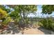 Outdoor patio space featuring shaded seating area and mature landscaping offering a serene backyard environment at 4720 Coronado S Way, Gulfport, FL 33711
