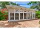 Backyard view showcasing brick pavers, large windows, and vibrant landscaping at 4901 W Estrella St, Tampa, FL 33629