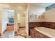 Bright bathroom featuring marble accents, a soaking tub, and a double vanity at 4901 W Estrella St, Tampa, FL 33629
