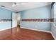 Bright bedroom with hardwood floors, access to a staircase, and natural light from a window at 4901 W Estrella St, Tampa, FL 33629