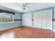 Spacious bedroom with hardwood floors, two closets, a ceiling fan, and natural light from a window at 4901 W Estrella St, Tampa, FL 33629