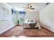 Bedroom with hardwood floors, a ceiling fan, and a large rug with a patterned design at 4901 W Estrella St, Tampa, FL 33629