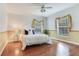 Bright bedroom featuring wood floors, stylish decor, and natural light from two windows at 4901 W Estrella St, Tampa, FL 33629