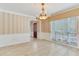 Charming dining room with a chandelier, tile flooring, and large window providing ample natural light at 4901 W Estrella St, Tampa, FL 33629