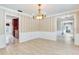 Dining room with tile floor, wainscoting, and a chandelier, with views into kitchen and other living areas at 4901 W Estrella St, Tampa, FL 33629