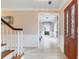 Inviting entryway showcasing a wood door, tile flooring, staircase, and access to other rooms in the home at 4901 W Estrella St, Tampa, FL 33629