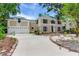Well-maintained home with a three-car garage and lush front yard at 4901 W Estrella St, Tampa, FL 33629