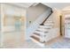 Open foyer with wood staircase, chandelier, and elegant wall paneling at 4901 W Estrella St, Tampa, FL 33629