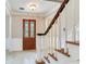 Inviting entryway showcasing a wood staircase and decorative glass front door at 4901 W Estrella St, Tampa, FL 33629
