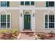 Close-up of an ornate front door with sidelights and brick pathway at 4901 W Estrella St, Tampa, FL 33629
