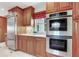Modern kitchen featuring stainless steel appliances and double ovens, complemented by sleek cabinetry at 4901 W Estrella St, Tampa, FL 33629