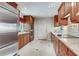 Modern kitchen with stainless steel appliances, granite countertops, tile backsplash, and bright lighting at 4901 W Estrella St, Tampa, FL 33629