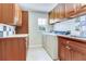 Well-lit laundry room featuring tile flooring, ample cabinet space, a sink, and a window at 4901 W Estrella St, Tampa, FL 33629