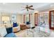 Comfortable living room with tile floor, plush seating, and french doors to the patio at 4901 W Estrella St, Tampa, FL 33629