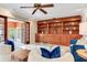 Open-concept living room with built-in shelving, tile floors, and French doors leading to a sunroom at 4901 W Estrella St, Tampa, FL 33629