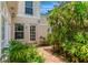 This lush side yard has brick pavers, a white door and an open green space at 4901 W Estrella St, Tampa, FL 33629