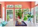 Elegant sun room with lots of light, a wooden table, and a floral centerpiece at 4901 W Estrella St, Tampa, FL 33629