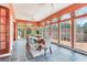 Inviting sun room featuring tile floors, large windows, and a dining table at 4901 W Estrella St, Tampa, FL 33629