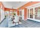 Bright sun room featuring a dining table, bench seating, and access to other living areas at 4901 W Estrella St, Tampa, FL 33629