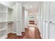 Walk-in closet with hardwood floors and multiple storage compartments at 4901 W Estrella St, Tampa, FL 33629