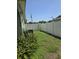 Narrow fenced backyard with green ground cover and some foliage at 534 N Larry Cir, Brandon, FL 33511