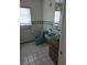 Vintage bathroom featuring green toilet and sink, tiled walls, and classic fixtures at 534 N Larry Cir, Brandon, FL 33511