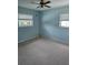 Bedroom with soft blue walls, neutral carpet, and natural light from two windows at 534 N Larry Cir, Brandon, FL 33511