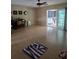 Large living room with sliding glass doors to the patio and wood laminate floors at 534 N Larry Cir, Brandon, FL 33511