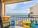 Balcony with colorful furniture offering serene views of the ocean and beach at 5633 Puerta Del Sol S Blvd # 310, St Petersburg, FL 33715