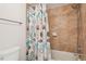 Full bathtub with unique ocean-themed shower curtain and tile surround at 5633 Puerta Del Sol S Blvd # 310, St Petersburg, FL 33715