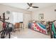 Bedroom features a daybed, ceiling fan, and window with blinds at 5633 Puerta Del Sol S Blvd # 310, St Petersburg, FL 33715