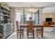 Dining area with a wooden table set, complemented by natural light and view of balcony at 5633 Puerta Del Sol S Blvd # 310, St Petersburg, FL 33715