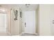 Entryway featuring a white front door, neutral walls, and decorative sea-themed accents at 5633 Puerta Del Sol S Blvd # 310, St Petersburg, FL 33715