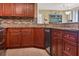 Kitchen area with wood cabinets, granite countertops, and modern appliances at 5633 Puerta Del Sol S Blvd # 310, St Petersburg, FL 33715