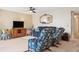 Well-lit living room with a large TV, cozy sofa and decorative accent chair at 5633 Puerta Del Sol S Blvd # 310, St Petersburg, FL 33715