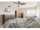 Cozy main bedroom featuring ceiling fan, dresser, and water view at 5633 Puerta Del Sol S Blvd # 310, St Petersburg, FL 33715