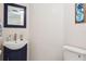 Powder room featuring toilet, small sink and decorative mirror at 5633 Puerta Del Sol S Blvd # 310, St Petersburg, FL 33715