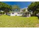 A large, fenced backyard featuring a shed with an attached carport at 7516 S Obrien St, Tampa, FL 33616