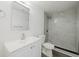 Well-lit bathroom featuring a new vanity, a modern shower and neutral colored tile at 7516 S Obrien St, Tampa, FL 33616