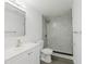 Bathroom with tiled shower, modern vanity, toilet, and towel rack at 7516 S Obrien St, Tampa, FL 33616