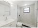 Bathroom with tiled shower, modern vanity, toilet, and towel rack at 7516 S Obrien St, Tampa, FL 33616