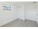 Bedroom with gray flooring, white walls and trim, closet, door and a window at 7516 S Obrien St, Tampa, FL 33616