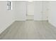 Bright bedroom featuring modern gray floors, white trim and walls, and an entryway at 7516 S Obrien St, Tampa, FL 33616