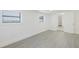 Spacious bedroom featuring modern gray floors, white trim and walls, and an entryway at 7516 S Obrien St, Tampa, FL 33616