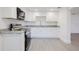 Bright kitchen showcasing white cabinets, gray countertops, and modern appliances at 7516 S Obrien St, Tampa, FL 33616