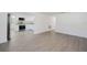 Spacious living room with newly installed light gray flooring and plenty of natural light at 7516 S Obrien St, Tampa, FL 33616