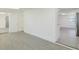 Open-concept floor plan with gray floors leading to the kitchen and other rooms at 7516 S Obrien St, Tampa, FL 33616