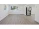Bright living room with gray floors, white walls, and stainless steel refrigerator at 7516 S Obrien St, Tampa, FL 33616